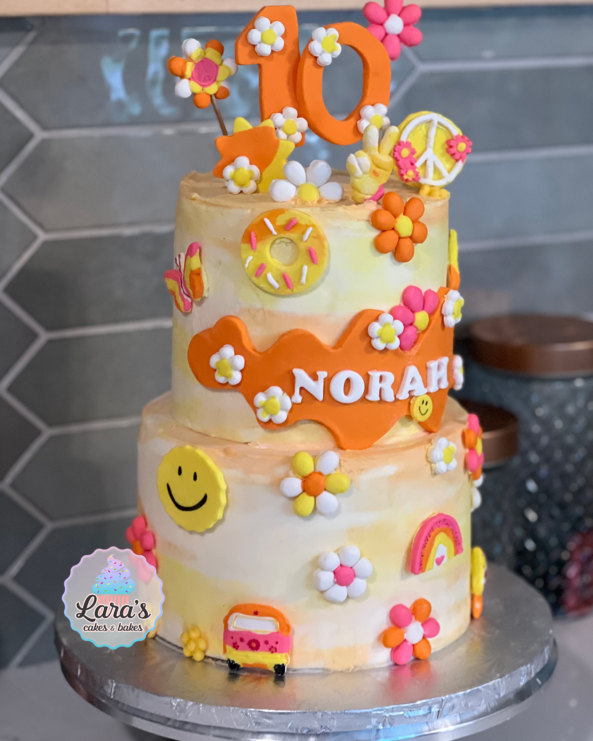 Two-tiered strawberry and lemon cake with buttercream and groovy fondant details