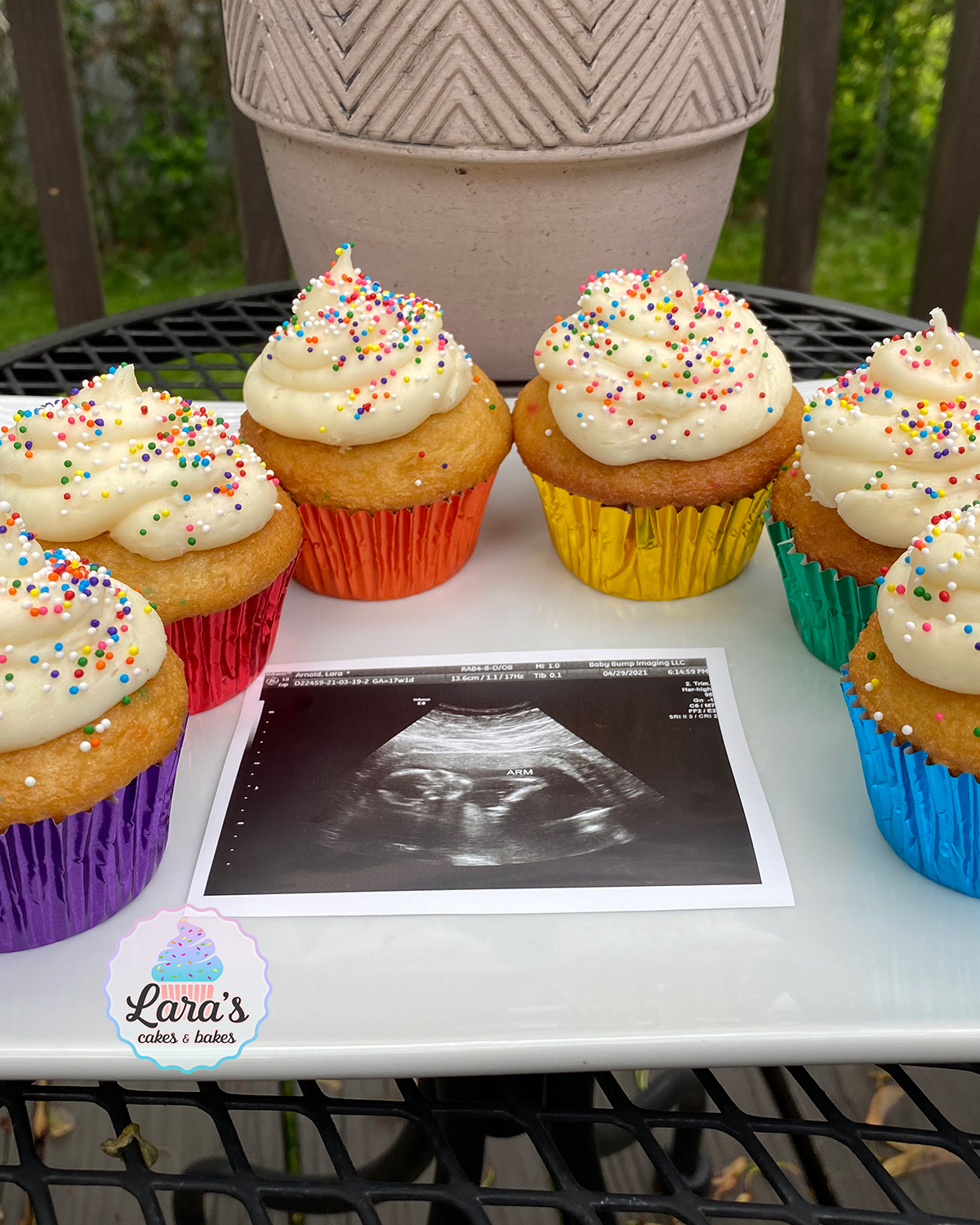 Rainbow gender reveal cupcakes with surprise sprinkle center