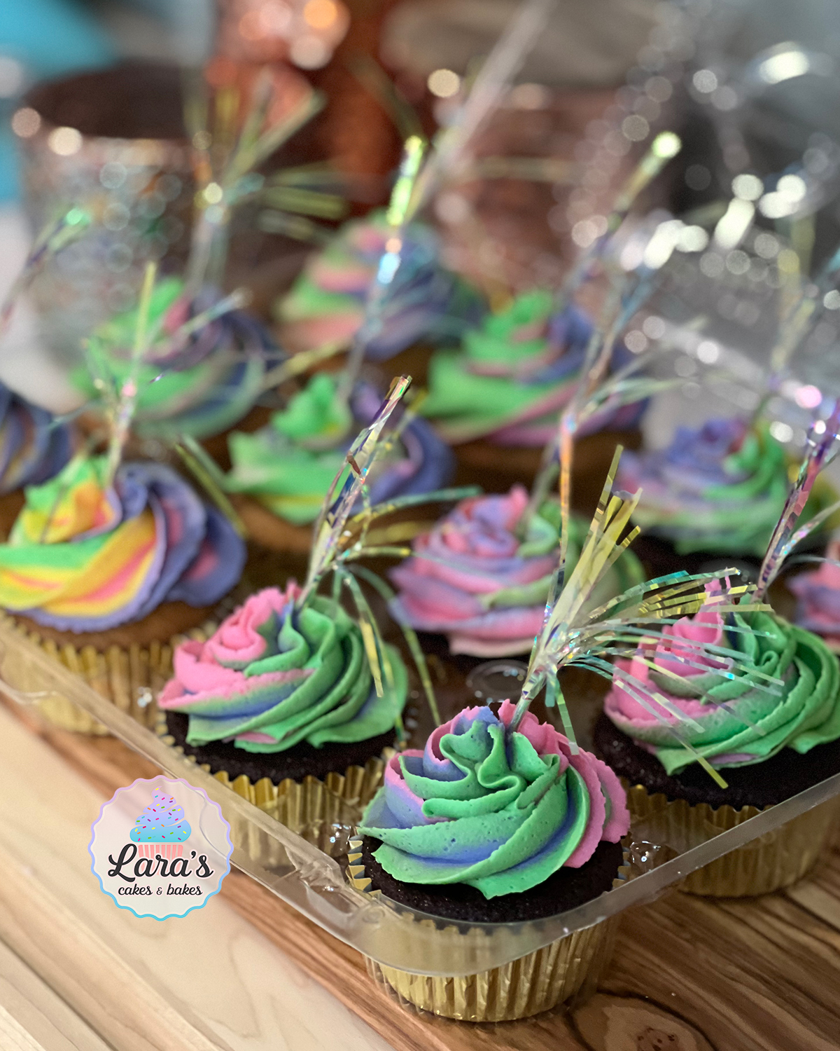 Gluten-free vanilla and chocolate cupcakes with rainbow buttercream and fireworks toppers