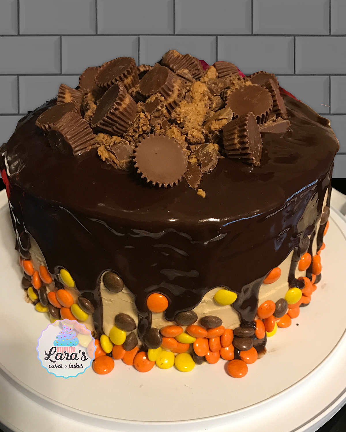 Chocolate cake with reeses peanut butter cups and reeses pieces and peanut butter buttercream and chocolate ganache