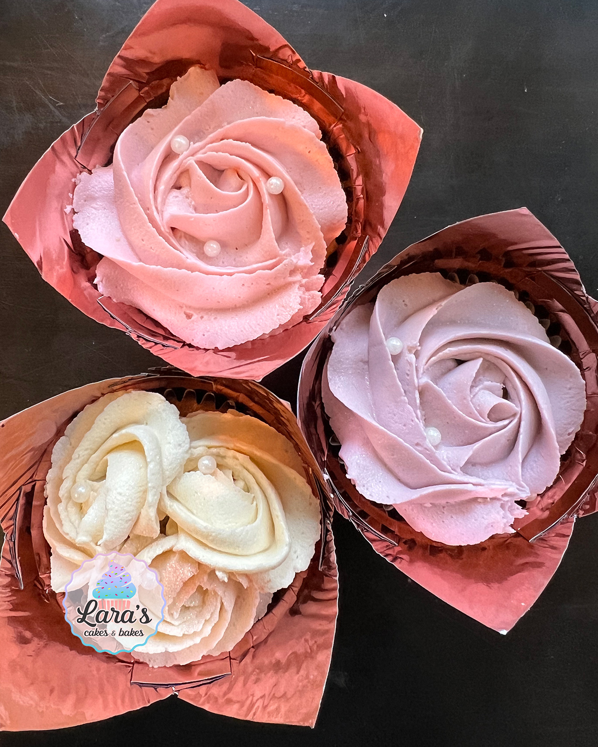 Caramel cupcakes with multi-colored buttercream roses and pearls