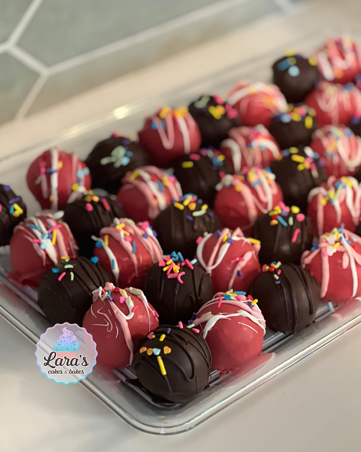 Red strawberry cake truffles, brown chocolate cake truffles, and rainbow sprinkles.